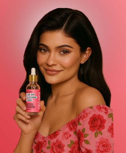 Woman holding a skincare serum bottle with a pink background