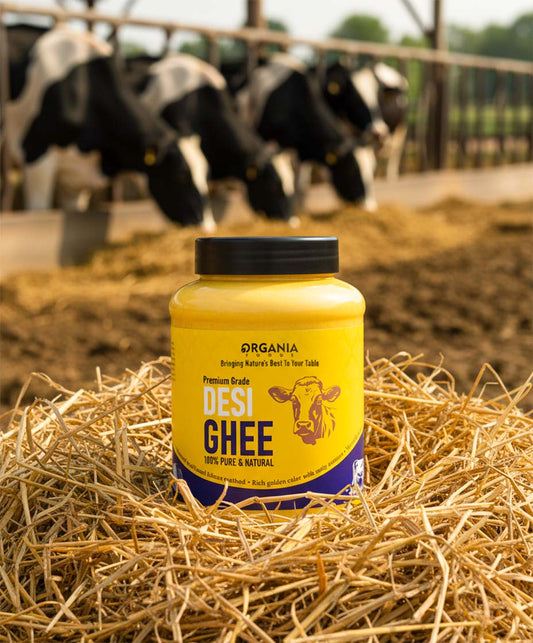 Jar of Desi Ghee with a cow illustration on a rustic wooden table.